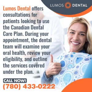 A smiling woman in a dental chair gives a thumbs up.